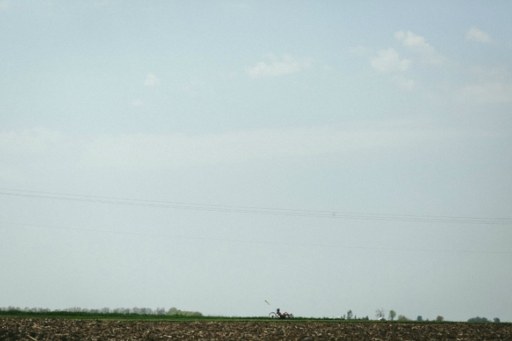 Ray on his trike from afar on the horizon. Ray says, “Riding the trike lets me forget I have ALS. [I feel] free.”