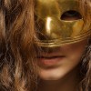 Girl wearing a gold mask.