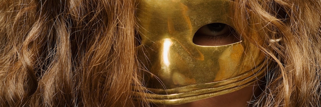 Coming Out to Friend and Family About Depression Girl wearing a gold mask.