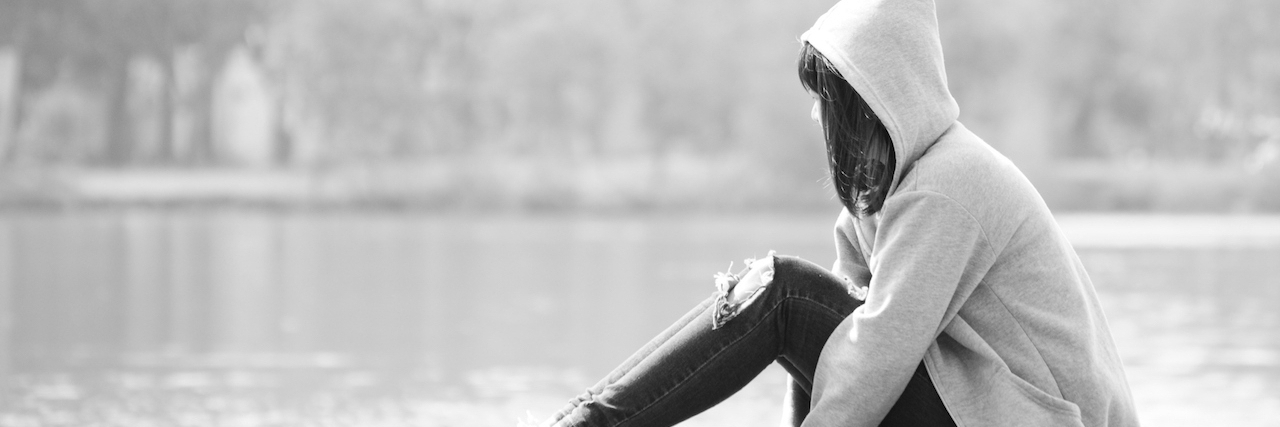 PTSD: A Letter to My Teenage Self Who Was Abused Sad teenage girl sitting alone near river.