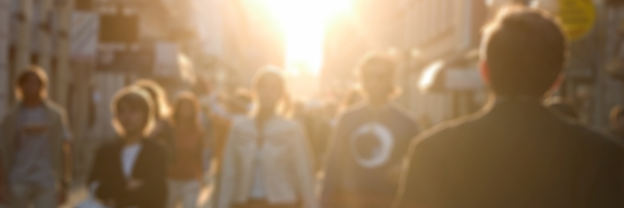 How to Respond to Mean Comments About Ostomy Bag a busy european street. People are blurred with a lens.