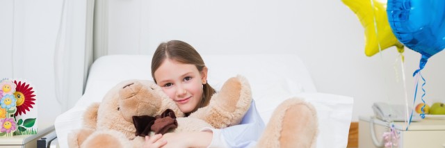 Child hugging a teddy bear in Hospital