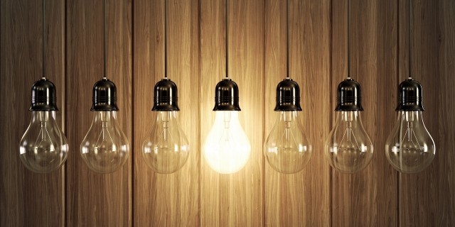 Why I Decided to Start a Foundation for My Rare Disease Seven light bulbs with glowing one on wooden background.