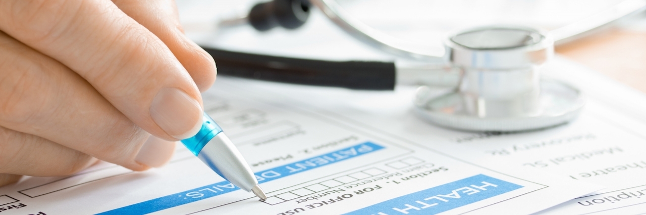 Excision Surgery for Endometriosis Medically Unnecessary for Insurance Doctor completing a Medical Claim Form by Stethoscope