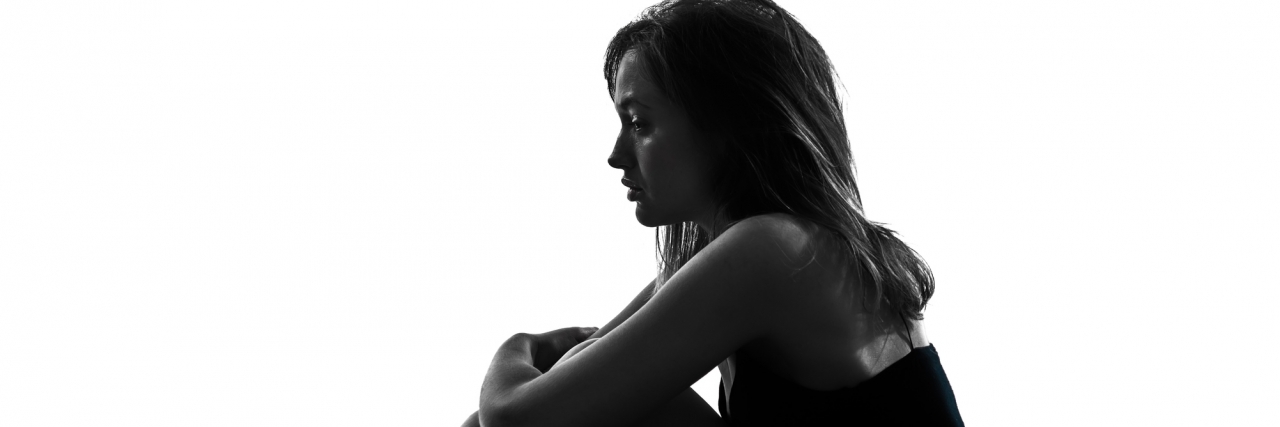 Depression Is More Than Feeling Sad depressed woman sitting alone in bed and hugging her knees