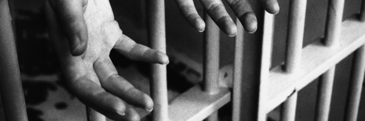 To the Prison Officer Who Saw My Potential When I Was Lost in My Mental Illness hands in prison cell