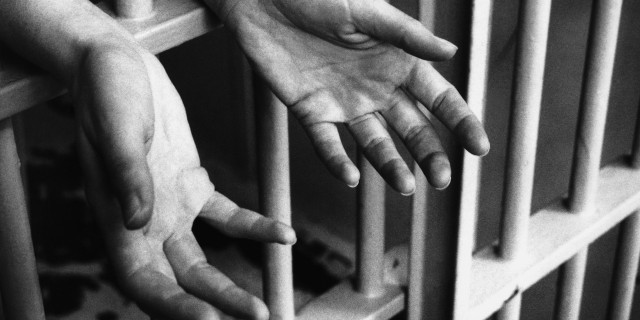 To the Prison Officer Who Saw My Potential When I Was Lost in My Mental Illness hands in prison cell