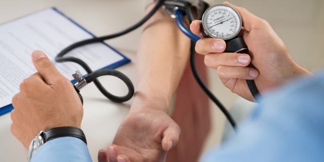 When a Doctor Finally Told Me What I Needed to Hear About Living With Hypochondria Close Up Of A Doctor Checking Blood Pressure Of A Patient