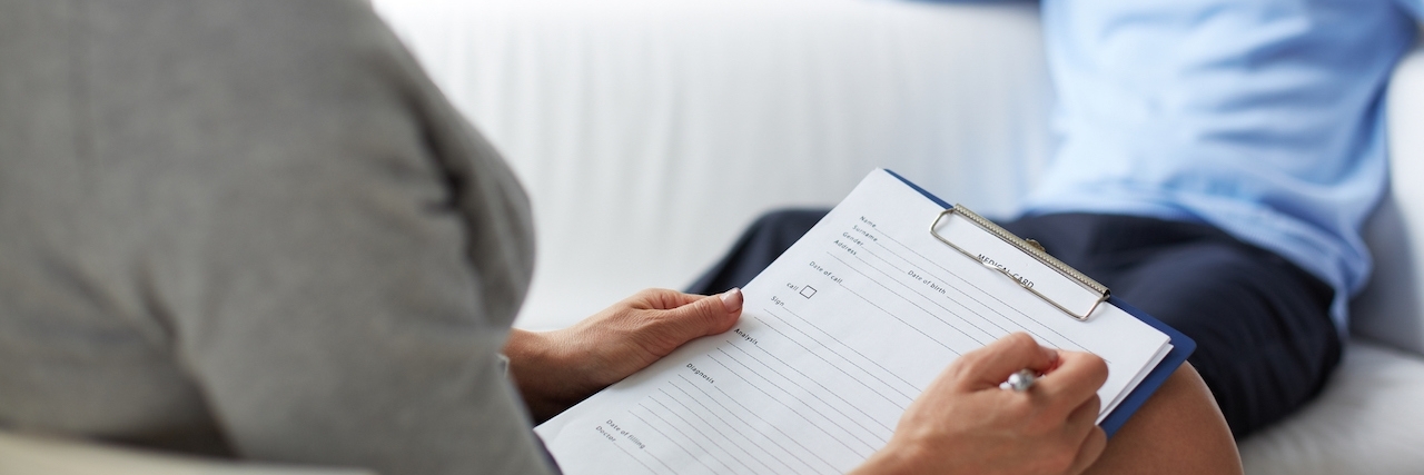 Depression: A Doctor's Perspective Woman psychologist filling in card of her patient