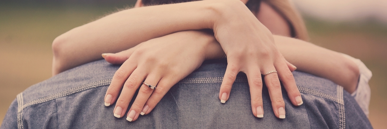 A Letter To Finance About My Depression and Anxiety A woman embracing her man with engagement ring on hand.