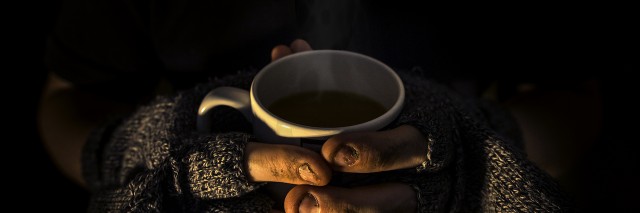 Homeless man with a hot steaming cup of tea
