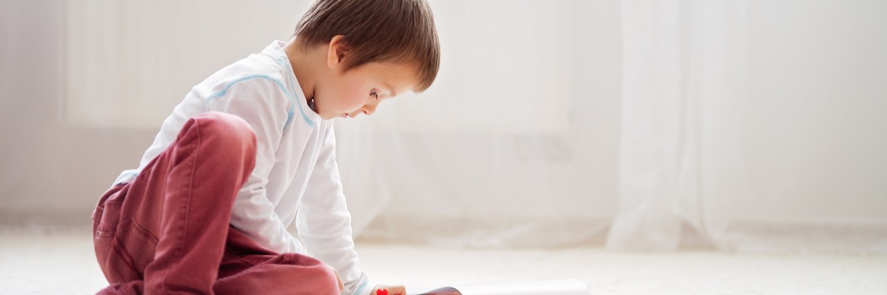 Suicide and Watching My Toddler Play With a Toy Gun Little child playing with lots of colorful plastic blocks indoor, building a fire truck and a fire house, reading from a manual and imagining