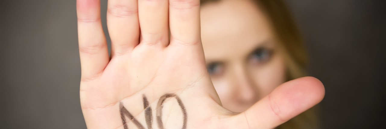 To the Friends I’ve Walked Away From Young woman with the word NO written on her hand.