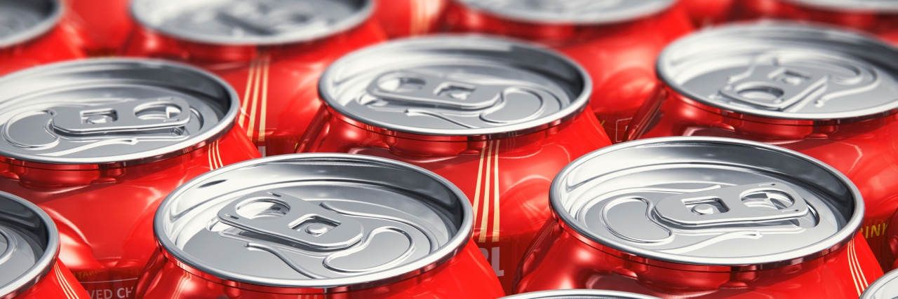 Macro view of color drink tin cans with cola soda beverage with selective focus effect