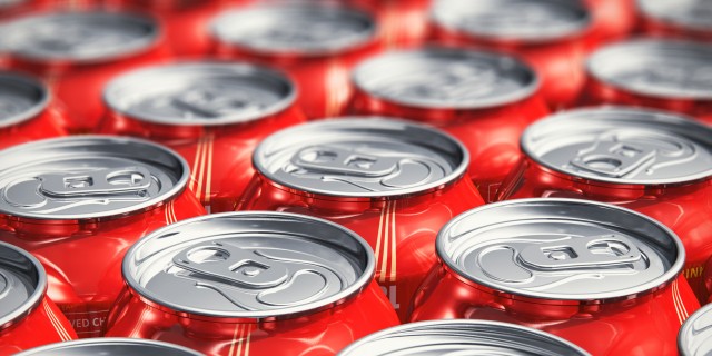 Macro view of color drink tin cans with cola soda beverage with selective focus effect