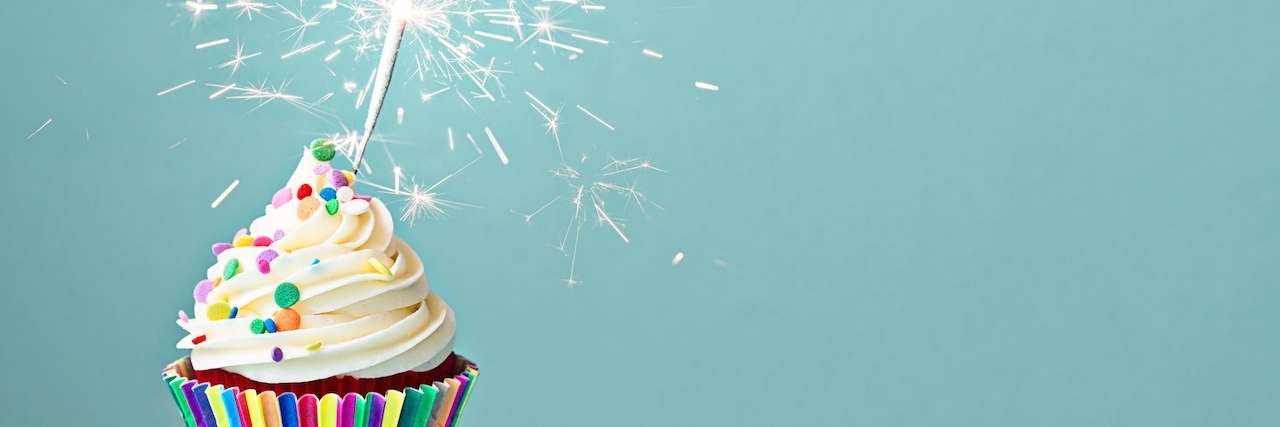 Multiple Sclerosis: What to Do on Diagnosis Day Cupcake decorated with colorful sprinkles and a sparkler