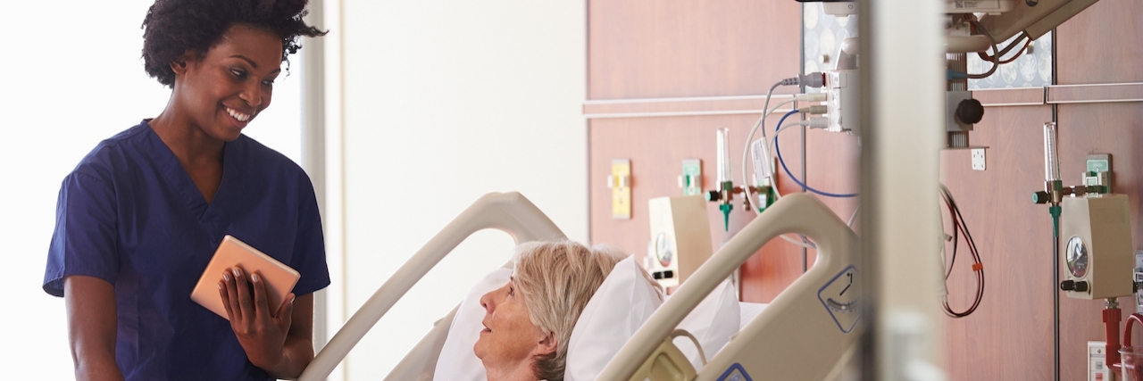 The Advantage of Having Ehlers-Danlos Syndrome as a Nurse Hospital Nurse With Digital Tablet Talks To Senior Patient