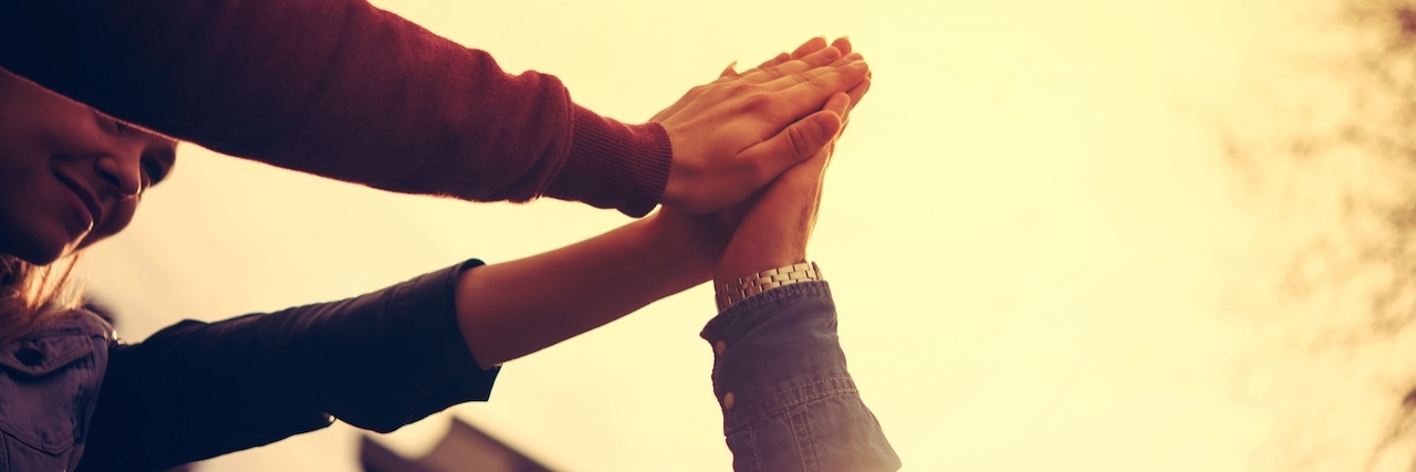 Depression: 'Crying for Help' Is Not Attention-Seeking three hands raised together