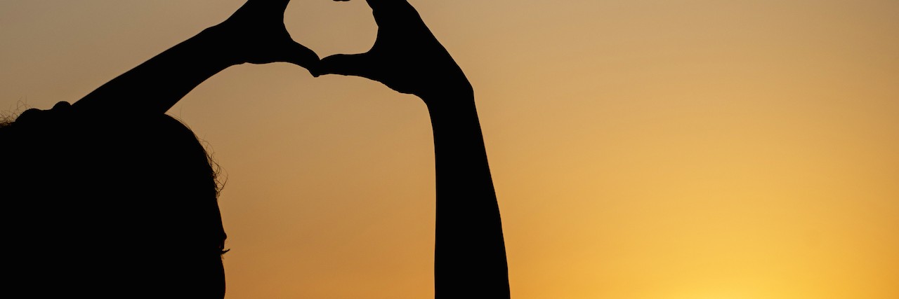 What Is 'Perfection' With Chronic Pain and Trigeminal Neuralgia silhouette woman making heart shape with sunset