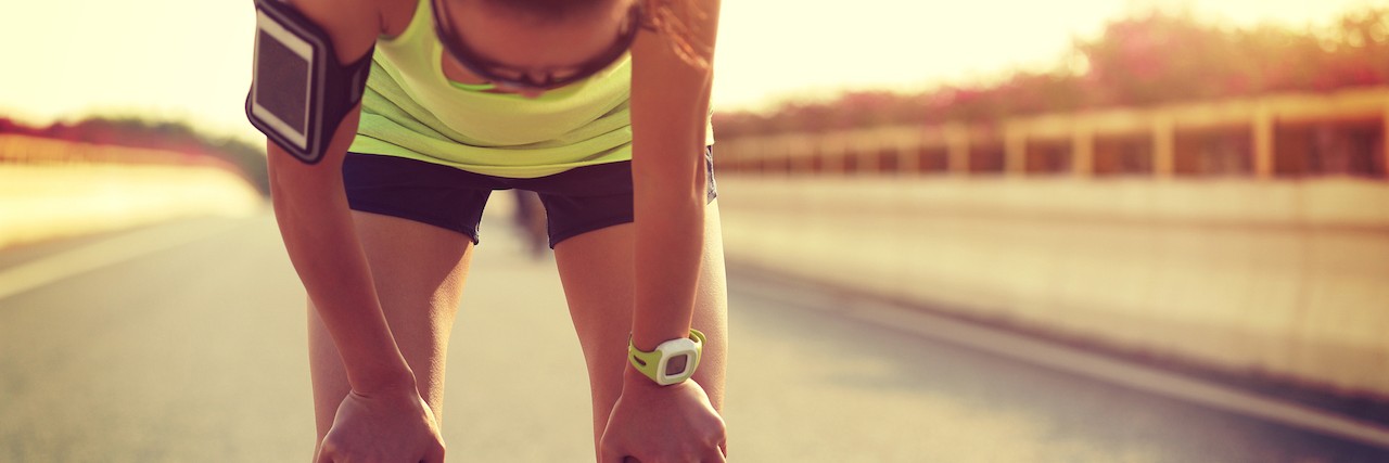 Over-Excercizing When You Have an Eating Disorder tired woman runner taking a rest after running hard