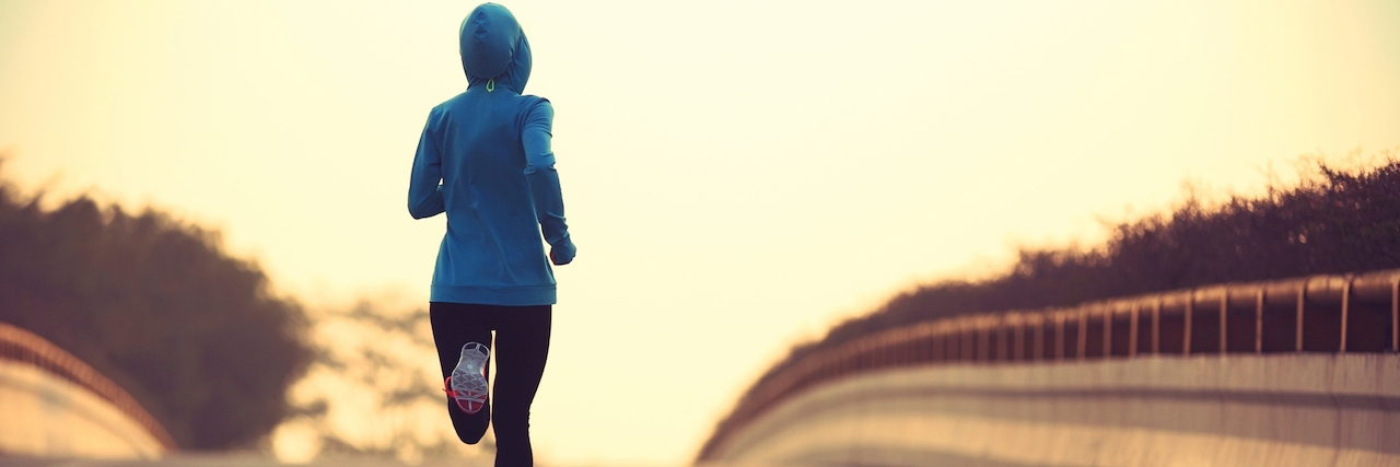 Getting Hurt During a Mixed Episode With Bipolar Disorder young fitness woman trail runner running on city road
