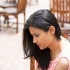 Closeup portrait, dull upset young woman sitting on bench, really depressed, down about something, isolated outdoors background.