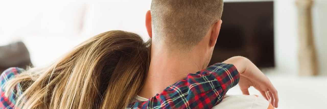 Response to People Judging Living With Boyfriend and Caregiver Couple relaxing on couch at home in the living room