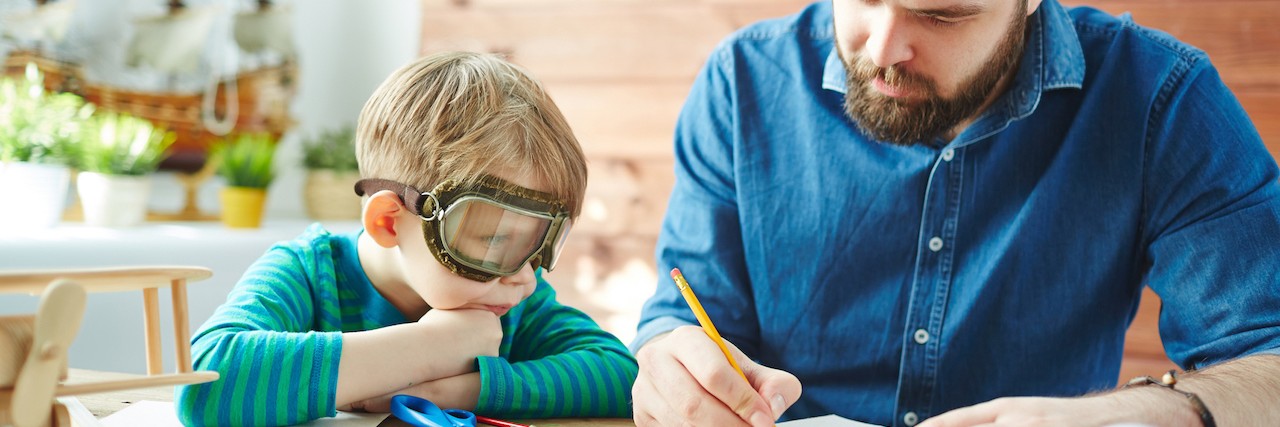 Father's Day Letter to Dads of Kids With Autism Spectrum Disorder Young man drawing sketch of paper toy for his son