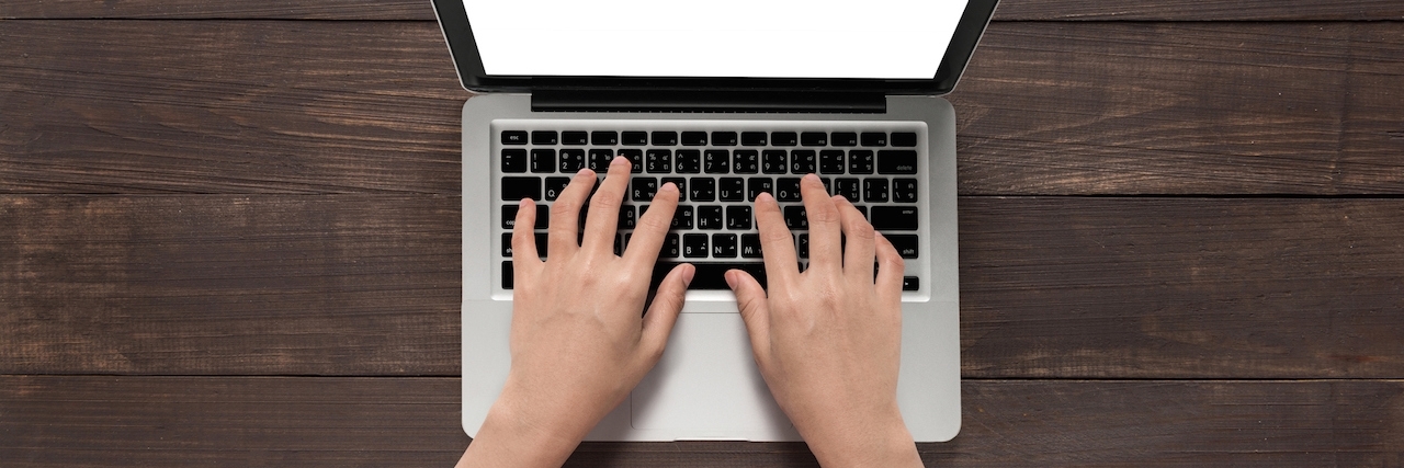What You Can Do to Change How Hypothyroidism Is Perceived Hands using with laptop on the wooden table.