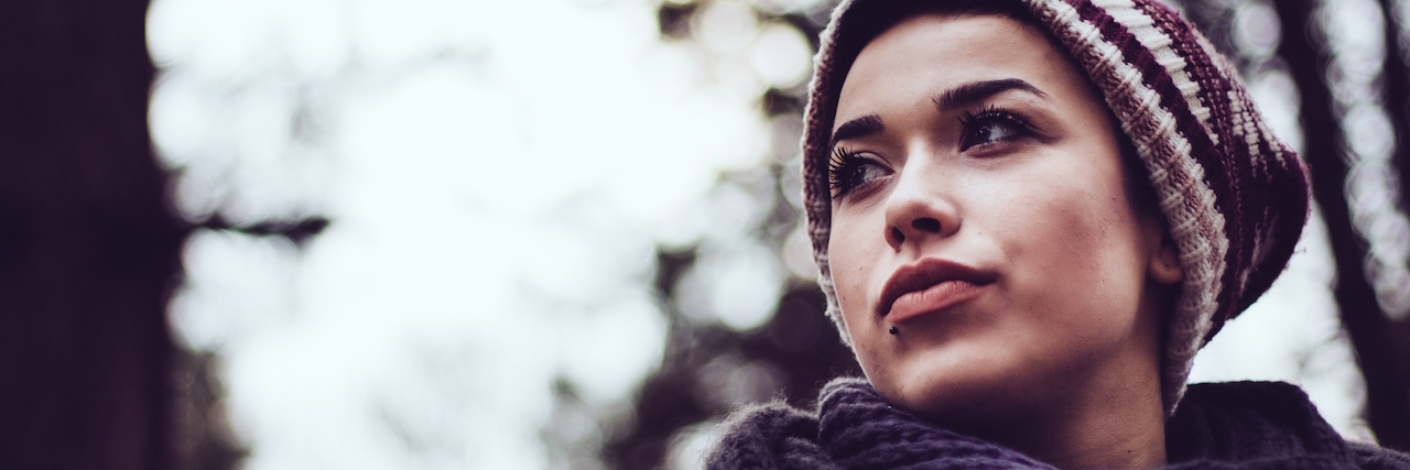 Woman in a forest or park, looking to the side