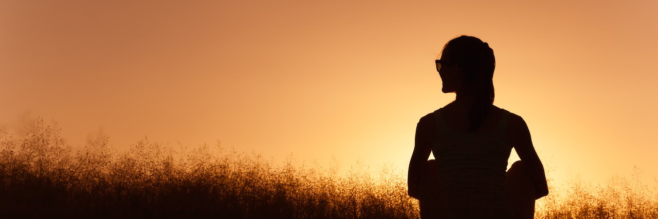 Receiving Treatment for Oropharyngeal Dysphagia: What to Know Young girl sitting in a grass field.