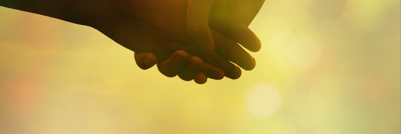 Learning to Cope After Surgery for Tricuspid Atresia couple holding hands in soft pastel tone