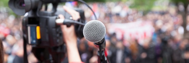 News camera filming a crowd