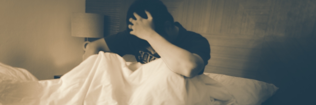 Mental Illness and Being Tired All the Time Blurry young man, unable sleep because of stress problems