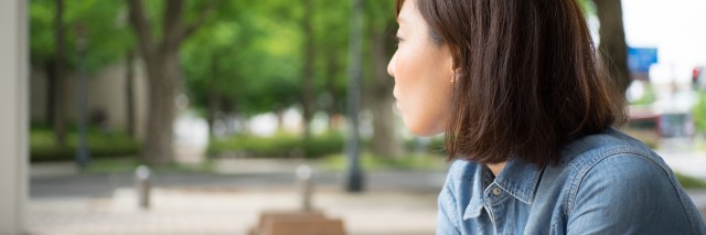 woman sitting on bench outdoors