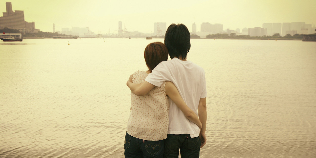 Dating a Person With an Ostomy: 5 Things to Know Couple with arms around each other, looking at landscape