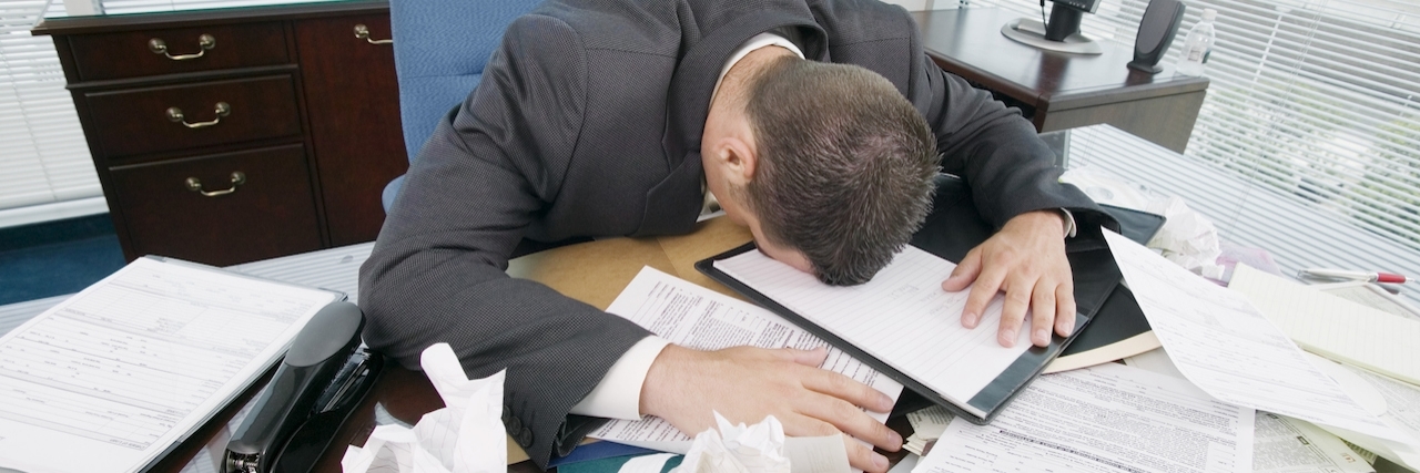 Workaholic With Depression: I Assumed It Was Just 'Burnout' Businessman face-down on messy desk