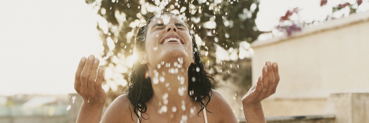 The Best Parts of Borderline Personality Disorder Woman on a Balcony Sits With Her Eyes Close, Splashing Water From a Bowl