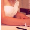 bride writing a note using a feather pen