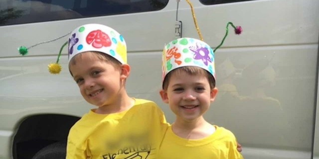 brothers smiling with bug hats on