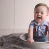 Meagan's son. Toddler with Down syndrome sitting in a bowl and laughing.