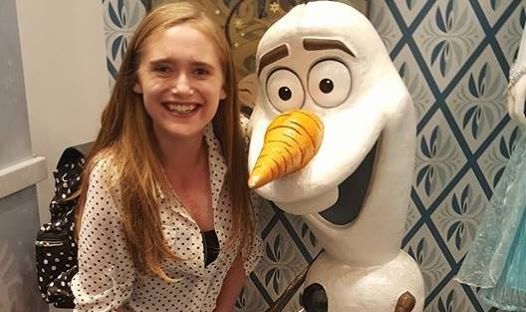girl sitting with olaf character