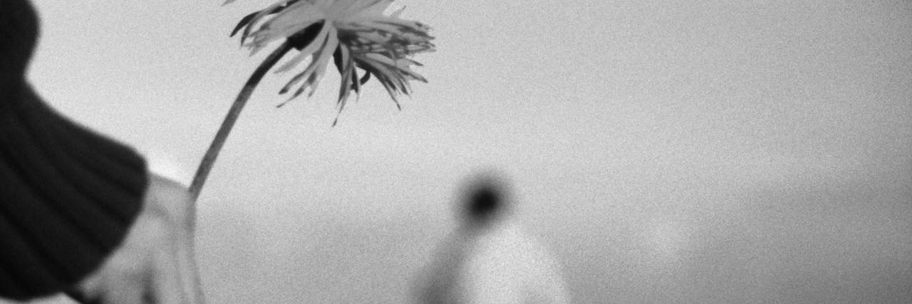 An Apology for My Anxiety Human hand holding flower