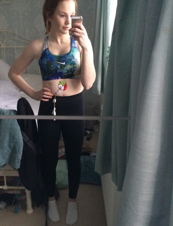 selfie of girl wearing a feeding tube and exercise clothes