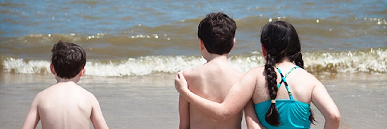 Raising a Family With Brown-Vialetto-Van Laere Syndrome Lauren's children arm in arm on the beach