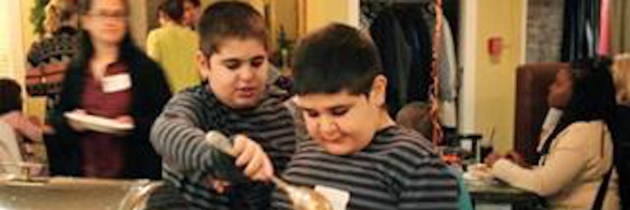 Tips for Going Out to Eat With an Autistic Child author's son with autism eating at a restaurant