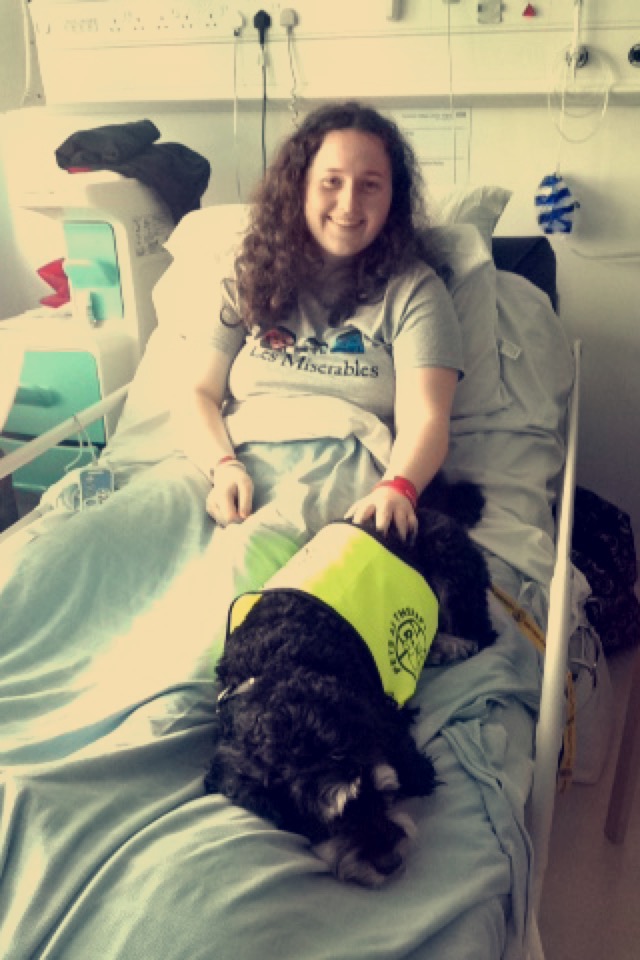 Mary with a service dog in the hospital