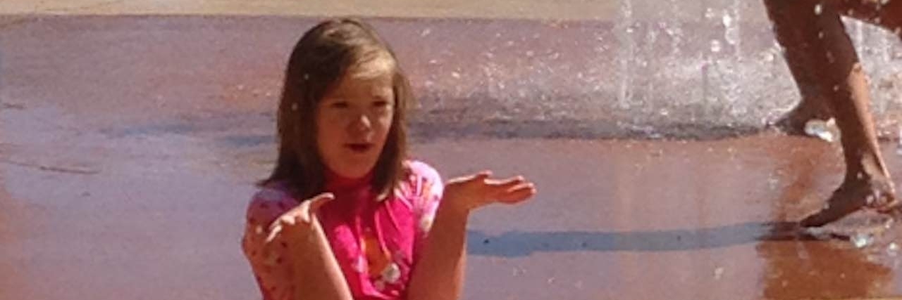 Mom Thanks Girl for Playing With Daughter With Down Syndrome daughter with down syndrome playing at waterpark