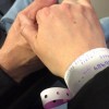 hand wearing hospital bracelet holding hand