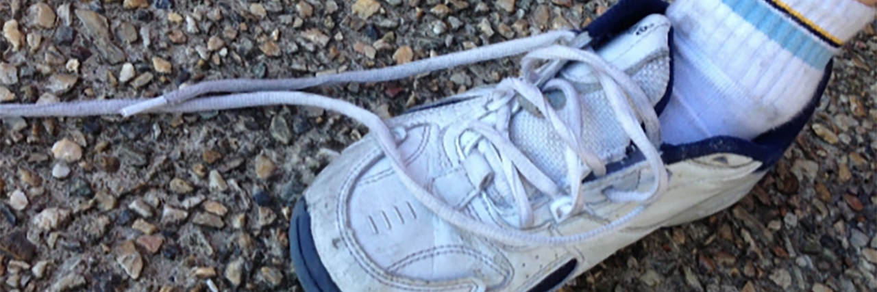 Rocket Laces Help Kids With Autism Tie Shoes Sneaker with untied shoelaces.